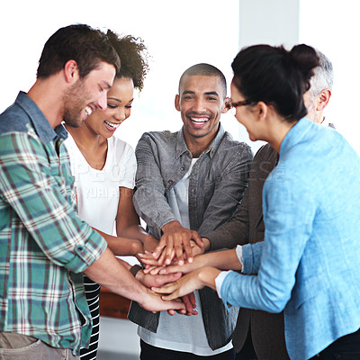 Buy stock photo Shot of a group of positive coworkers standing in a huddle in an office