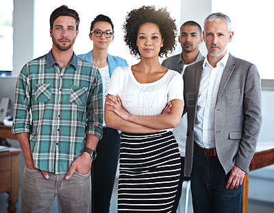 Buy stock photo Portrait of a group of focused coworkers standing in an office