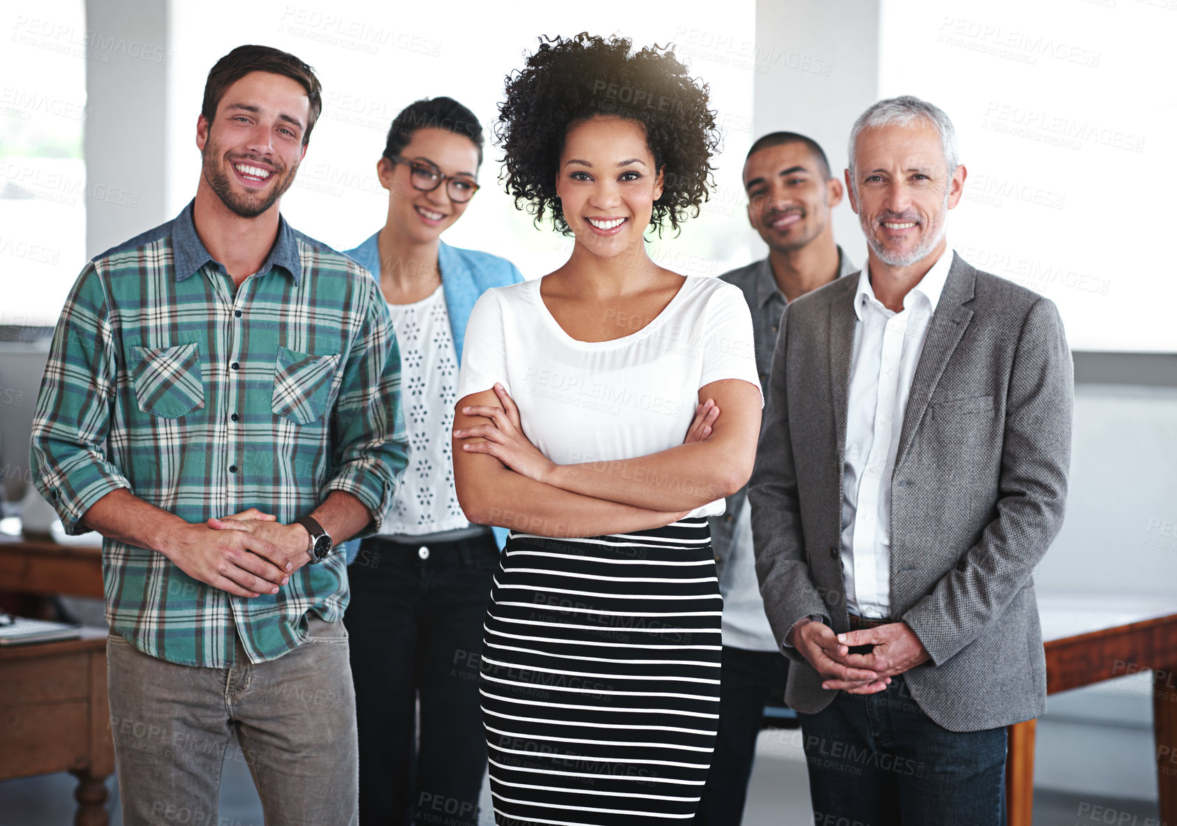 Buy stock photo Portrait of a group of smiling coworkers standing in an office