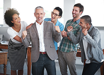 Buy stock photo Portrait of a group of colleagues cheering while standing in an office