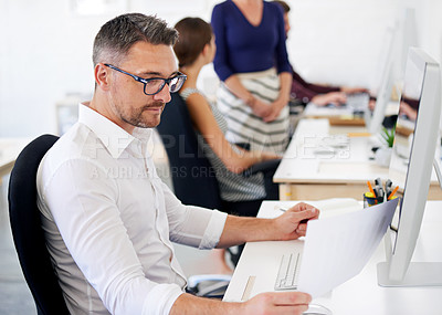 Buy stock photo Businessman, paper and reading with computer in office for campaign planning, update media listing and report. Public relations employee, online and working on technology for research market trends.