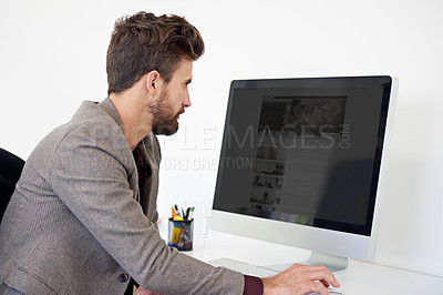 Buy stock photo Shot of a male designer working on his desktop computer