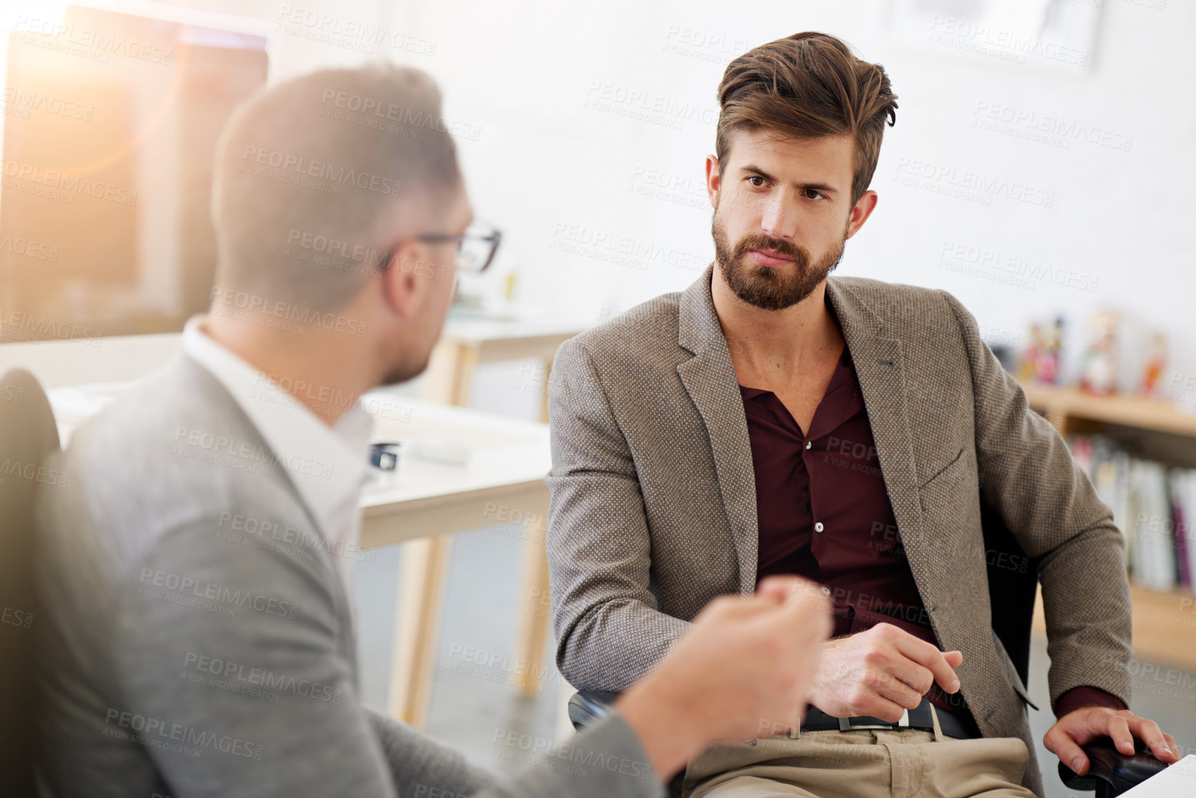 Buy stock photo Cropped shot of two businessmen having a discussion in the office