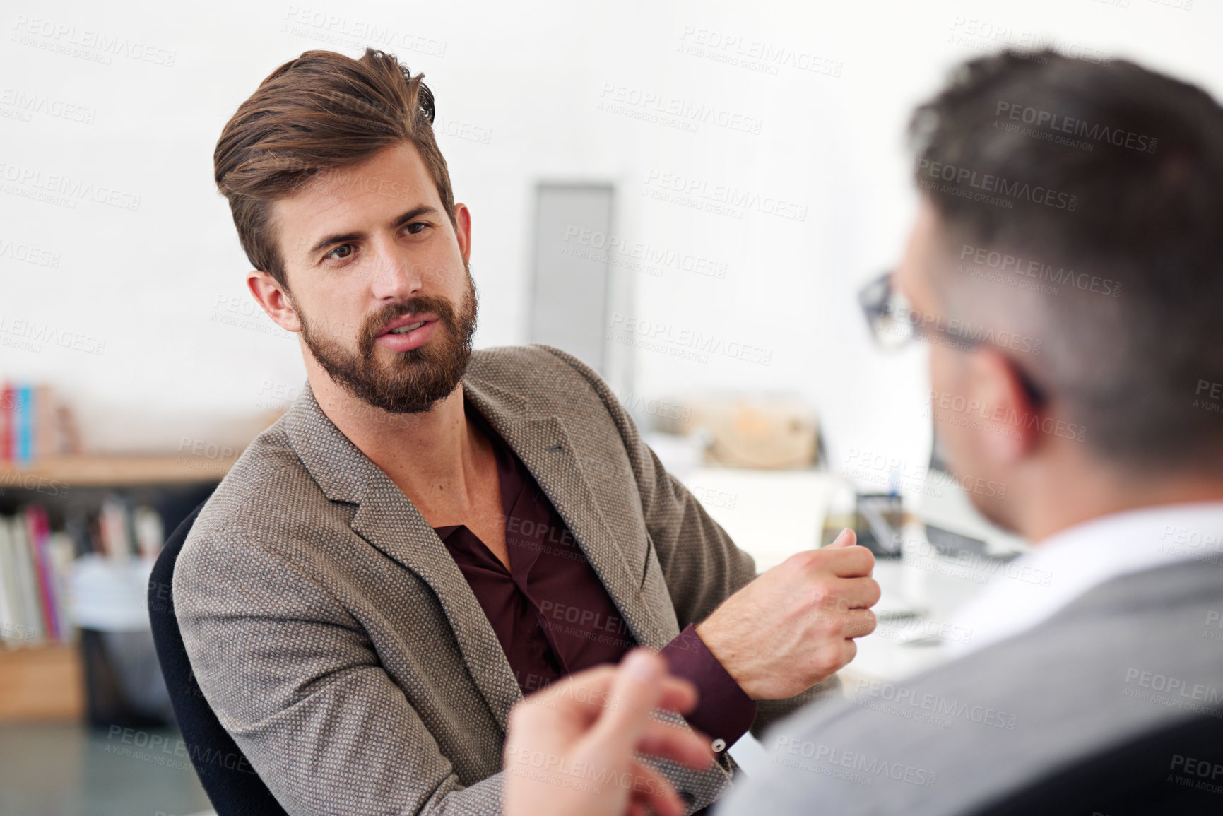 Buy stock photo Cropped shot of two businessmen having a discussion in the office