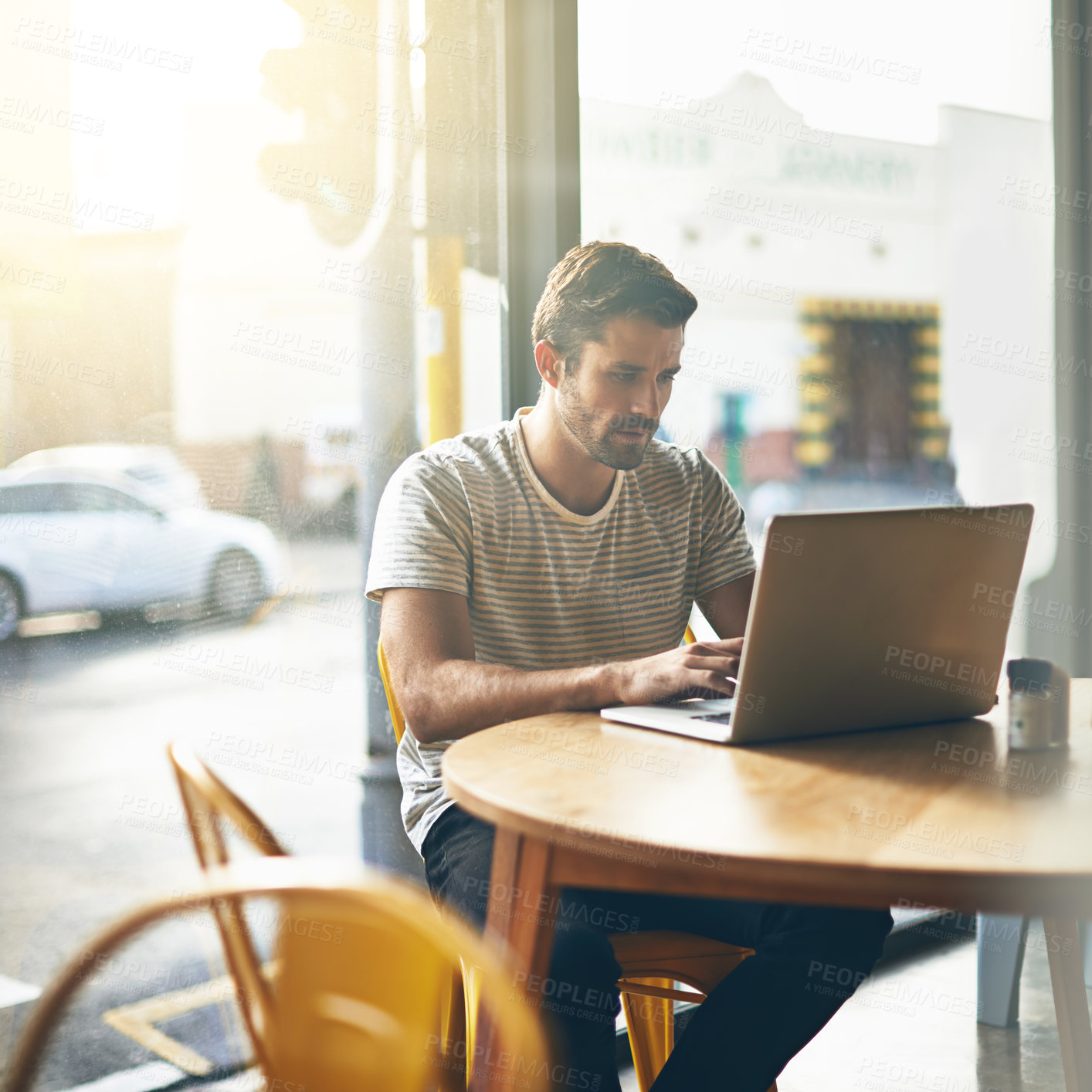 Buy stock photo Coffee shop, typing and serious man with laptop and lens flare doing code work in a cafe. Tech, email and male freelancer customer at restaurant with online job and computer writing with focus