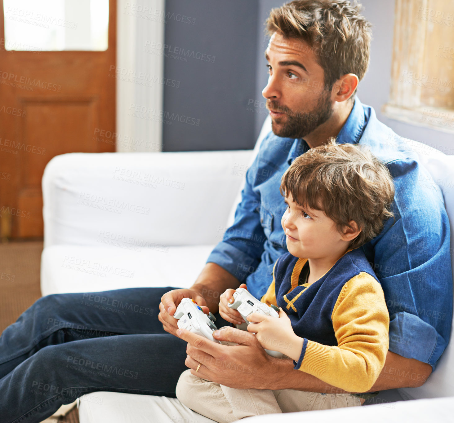 Buy stock photo Online game, father and son on a couch, bonding and relax at home, cheerful and happiness. Family, dad and boy with parent, happy male child and kid with controller, entertainment and multiplayer app