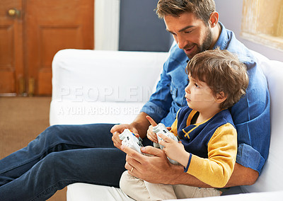 Buy stock photo Gaming, dad and son on a sofa, playful and bonding with fun, happiness and chilling at home. Family, father and boy with parent, male child and kid with controller, video games and multi player app