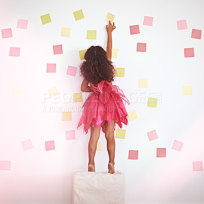 Buy stock photo Child, girl and against wall to play with sticky notes, colors and creativity with standing on ottoman. Kid, female person and home with childhood activity for development, growth and cute in dress