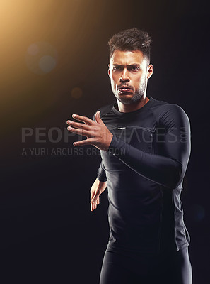 Buy stock photo Workout, running and athlete man in studio for sprint exercise, marathon or competition with black background. Sport, lens flare and male model person for speed, endurance training and wellness
