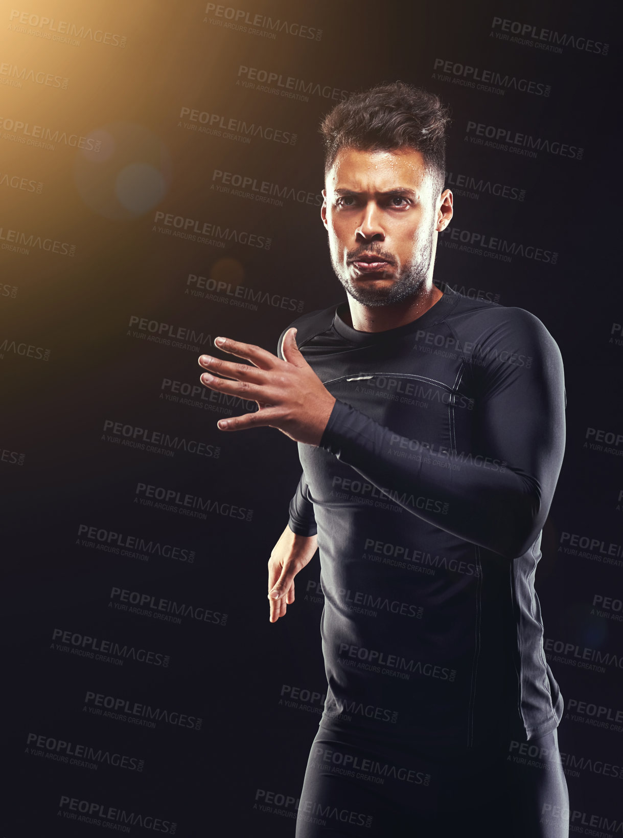 Buy stock photo Workout, running and athlete man in studio for sprint exercise, marathon or competition with black background. Sport, lens flare and male model person for speed, endurance training and wellness