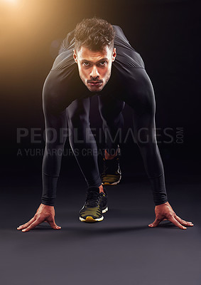 Buy stock photo Runner, portrait and man ready in studio with start, confidence or race challenge for health, wellness and power. Serious, running and athlete on black background for exercise, fitness or competition