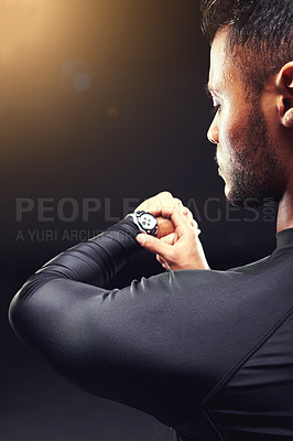 Buy stock photo Athlete, man and check watch with wellness for performance monitor, training progress and exercise time with rear view. Person, clock and running challenge for fitness in studio on black background