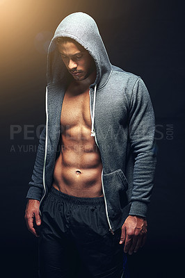 Buy stock photo Fitness, hoodie and man with muscles on black background for exercise, training and intense workout. Sweat, sports and serious person with strength for performance, wellness and health in studio