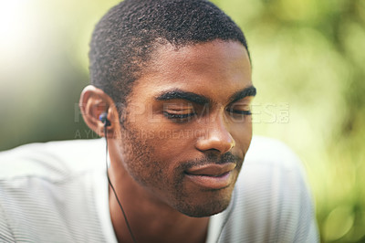 Buy stock photo Face, music and relax with black man in nature or park outdoor for summer, peace and quiet. Garden, radio and wellness with calm young person streaming audio or sound on earphones in backyard