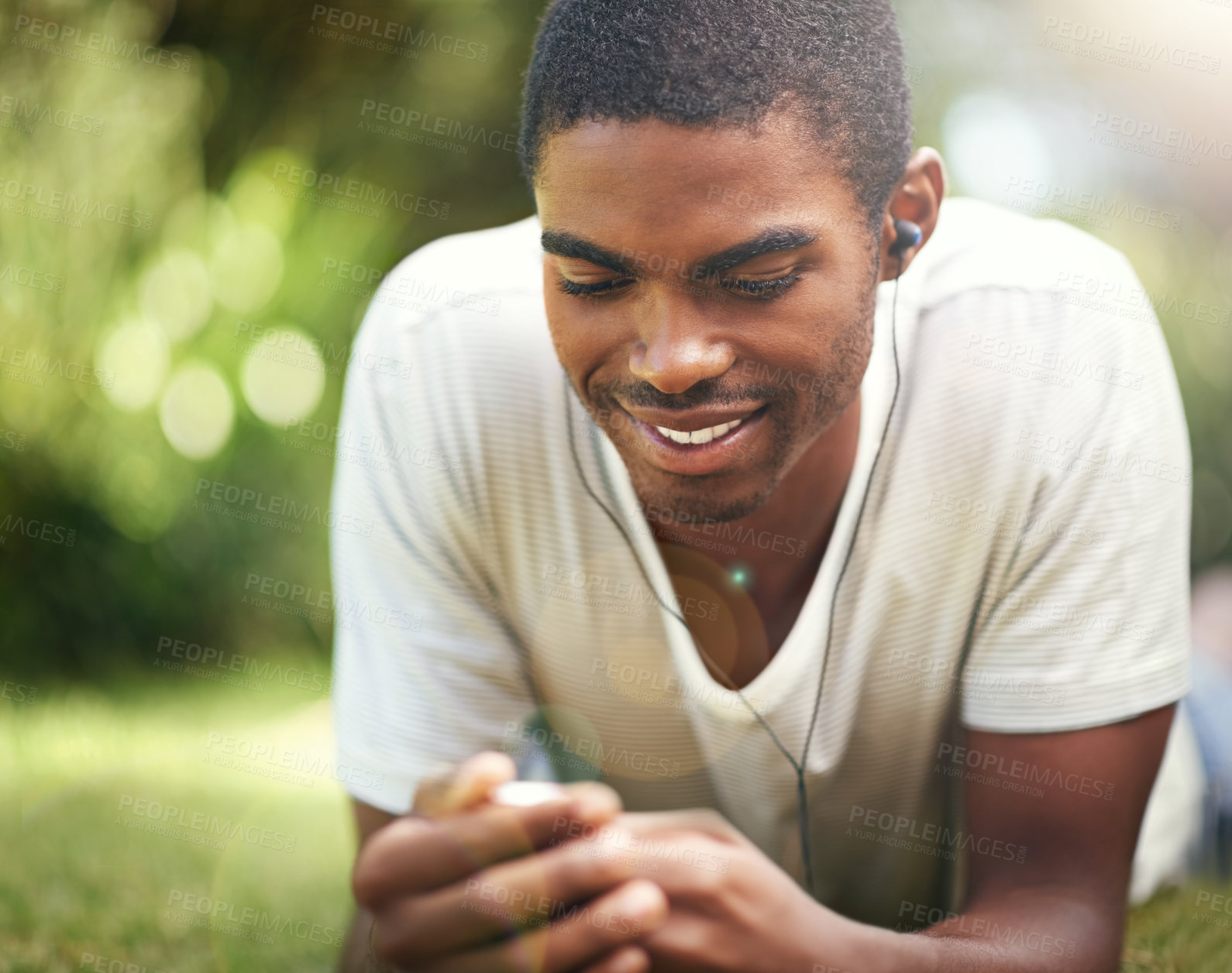 Buy stock photo Music, summer and smile with black man on grass in garden, park or field to relax outdoor. Face, nature and wellness with happy young person streaming or listening to radio on headphones in fresh air