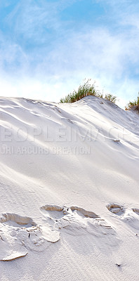 Buy stock photo Copyspace with landscape of footprints in sand dunes on west coast of Jutland in Loekken, Denmark, and cloudy blue sky background. Peaceful nature scenery for travel and tourism in an empty desert