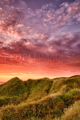 Buy stock photo Copyspace landscape of sunset on coast of Jutland in Loekken, Denmark. Sun setting on empty beach at dusk over hills and meadows. Dramatic sunrise in morning with copy space. Pink sky on coastline