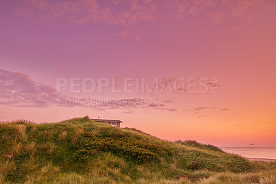 Buy stock photo Copyspace landscape of a sunset on the west coast of Jutland in Loekken, Denmark. Sun setting on the horizon on an empty beach over the ocean and sea with copy space. Cloudy pink sky in the morning