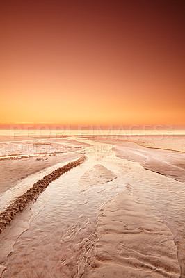 Buy stock photo Seascape and landscape of golden sunset on the west coast of Jutland in Loekken, Denmark. Sun setting on the horizon on an empty beach at dusk and over the ocean and sea in the evening with copyspace