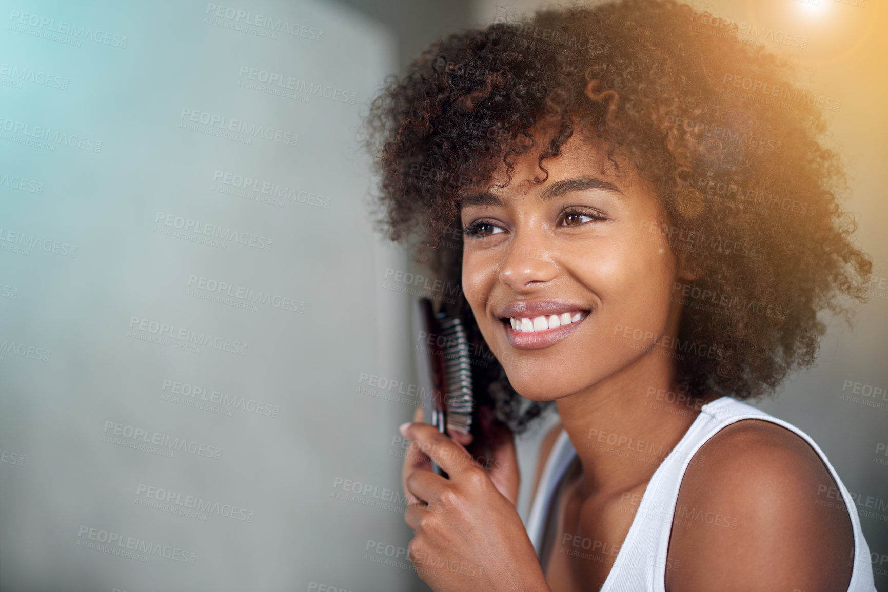 Buy stock photo Natural, beauty and black woman brush hair in morning, bathroom and glow on skin from skincare. African, hairstyle and girl with happiness from self care, cosmetics and grooming curly afro with comb