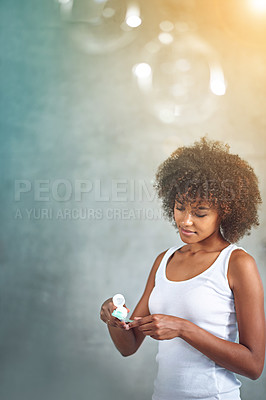 Buy stock photo Cropped shot of a young woman brushing her teeth in the bathroom