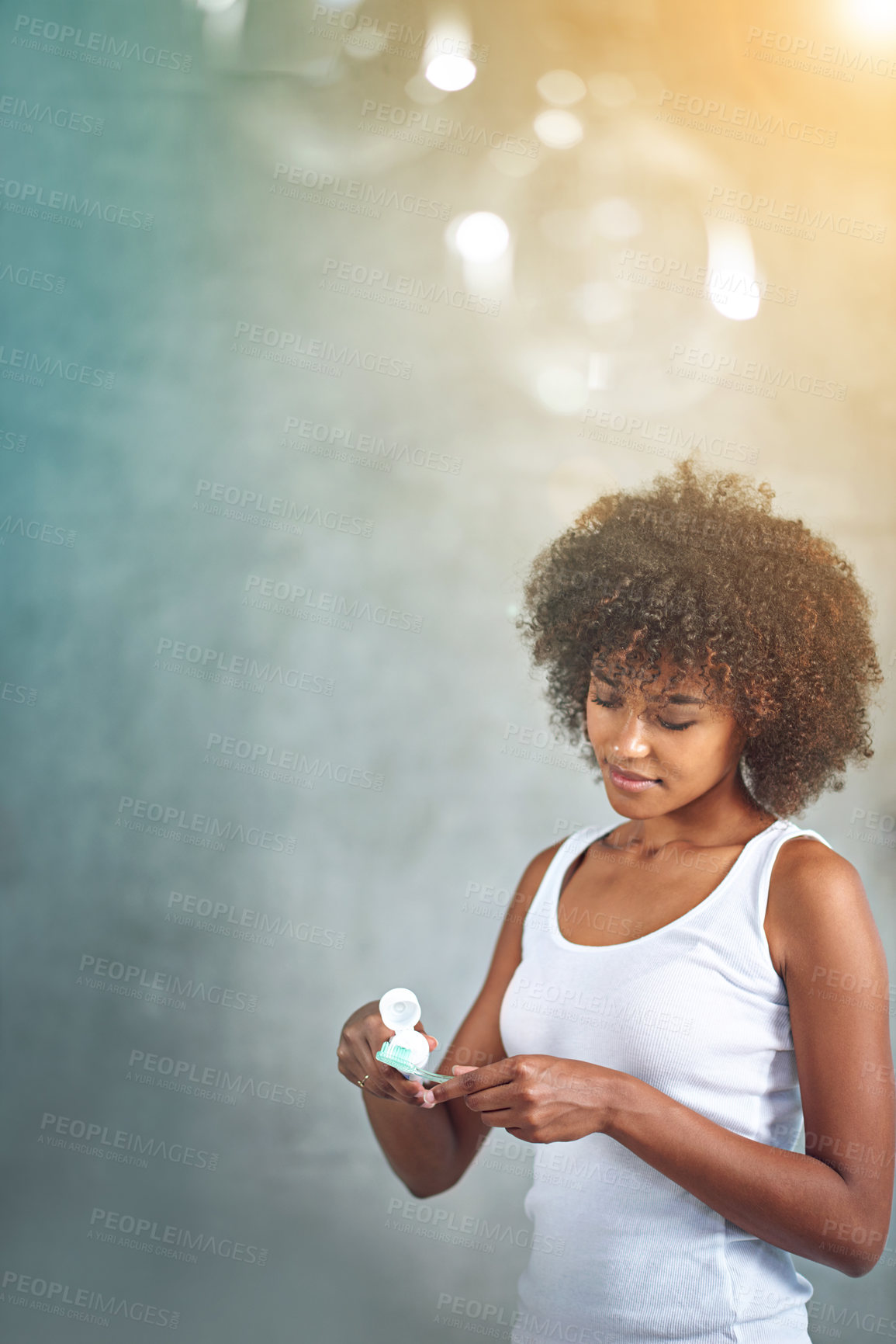 Buy stock photo Cropped shot of a young woman brushing her teeth in the bathroom