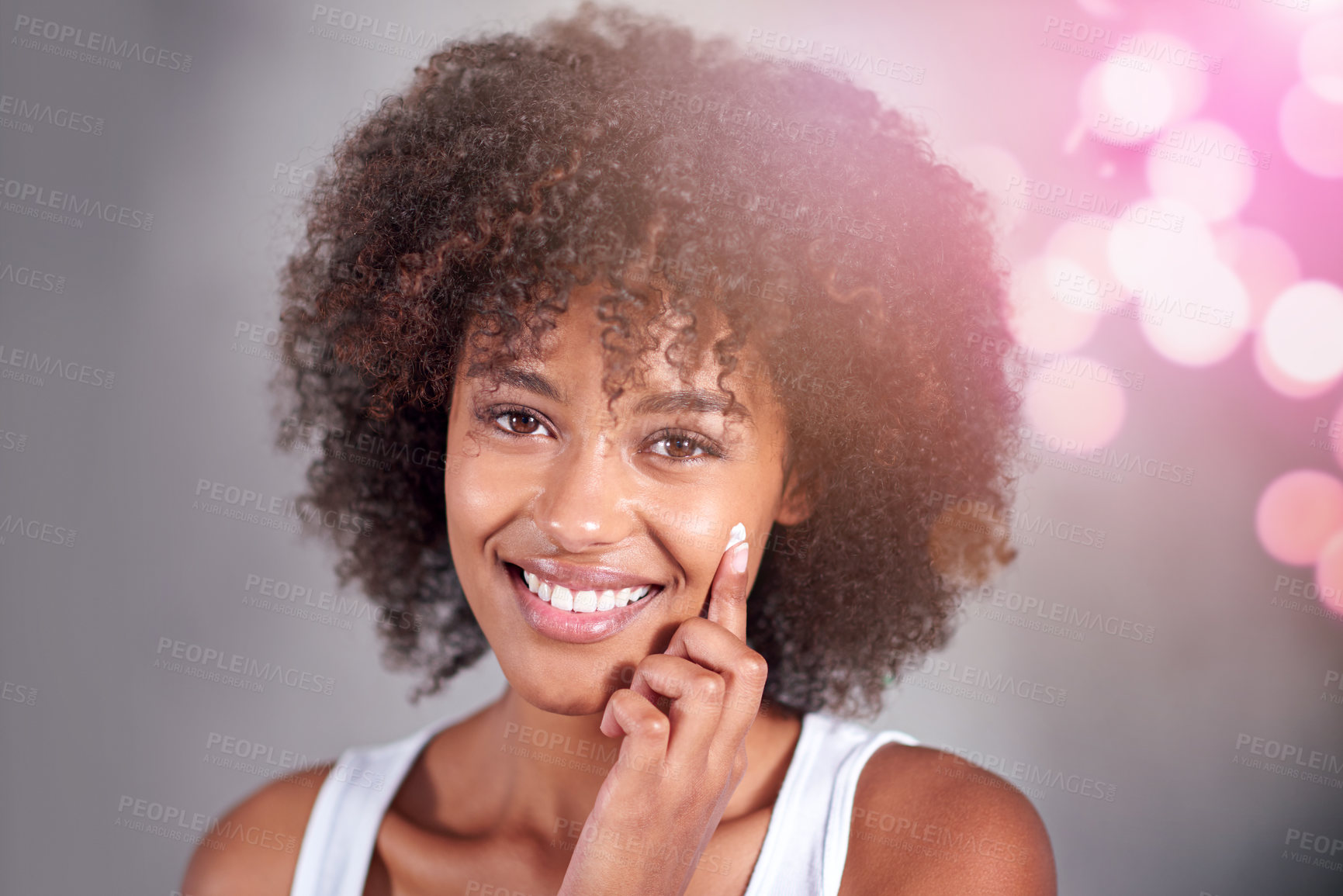 Buy stock photo African woman, portrait and skin cream with smile, wellness and afro in home bathroom to start morning routine. Girl, person and serum with cosmetics, bokeh or transformation with beauty in apartment