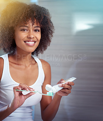 Buy stock photo Cropped portrait of a young woman brushing her teeth in the bathroom