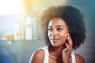 Buy stock photo African woman, beauty and facial cream with smile, wellness or afro in home bathroom for morning routine. Girl, person and serum with cosmetics, skincare or transformation with self care in apartment