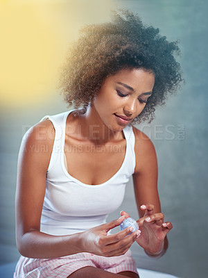 Buy stock photo African woman, bathroom and container for cream, skincare and start morning routine in apartment. Girl, person and serum for change, cosmetics and benefits for facial skin with transformation in home