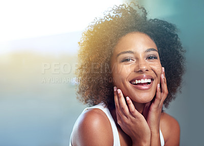 Buy stock photo Cropped portrait of a young woman touching her face in the bathroom