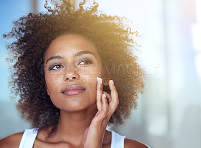 Buy stock photo African woman, skincare and cream in bathroom for beauty, wellness and afro in home to start morning routine. Girl, person and serum for cosmetics, change and transformation with face in apartment