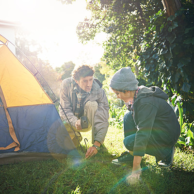 Buy stock photo Father, child and hammer tent for camping outdoor in nature on vacation, bonding together and sunset. Dad, boy and preparing camp, learning and helping in forest for travel, holiday and adventure.