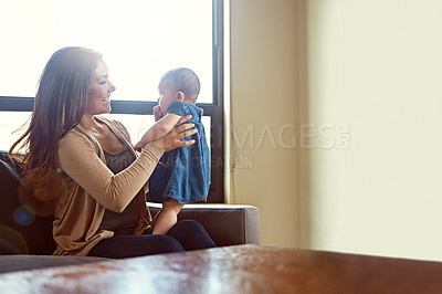 Buy stock photo Shot of a mother holding her baby girl at home