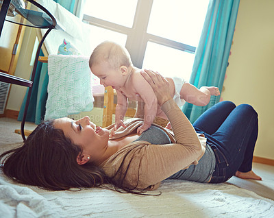 Buy stock photo Shot of a mother with her baby girl at home