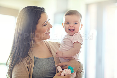 Buy stock photo Mother, carrying or laughing baby girl in house living room, nursery or family home bedroom in trust, love or support. Smile, happy mom or infant child in funny, goofy and comic bonding game for kids