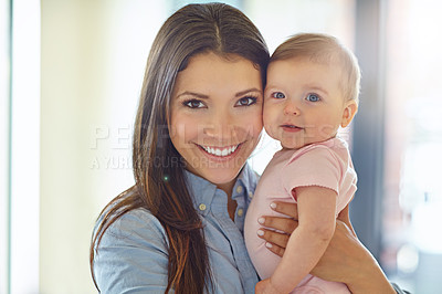 Buy stock photo Portrait of a mother holding her baby girl at home