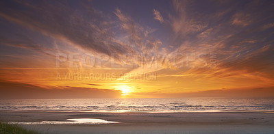 Buy stock photo Seascape and landscape of a golden sunset on the west coast of Jutland in Loekken, Denmark. Beautiful cloudscape on an empty beach at dusk. Clouds over the ocean and sea in the evening with copyspace 