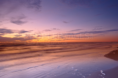 Buy stock photo Seascape and landscape of a beautiful sunset on the west coast of Jutland in Loekken, Denmark. Sun setting on the horizon on an empty beach at dusk over the ocean and sea in the evening