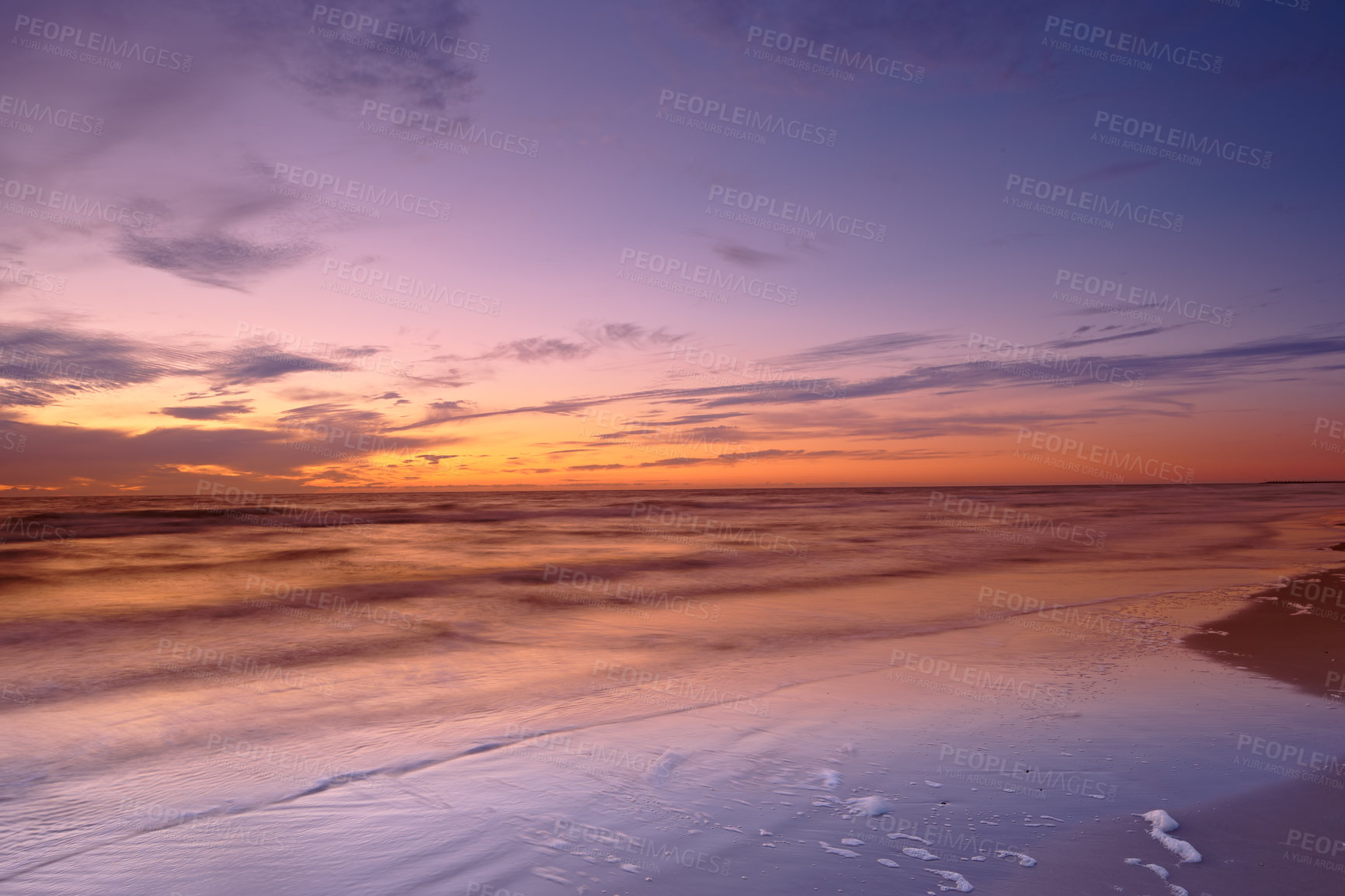 Buy stock photo Seascape and landscape of a beautiful sunset on the west coast of Jutland in Loekken, Denmark. Sun setting on the horizon on an empty beach at dusk over the ocean and sea in the evening