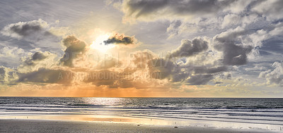 Buy stock photo Seascape and landscape of a golden sunset on the west coast of Jutland in Loekken, Denmark. Beautiful cloudscape on an empty beach at dusk. Clouds over the ocean and sea in the morning with copyspace