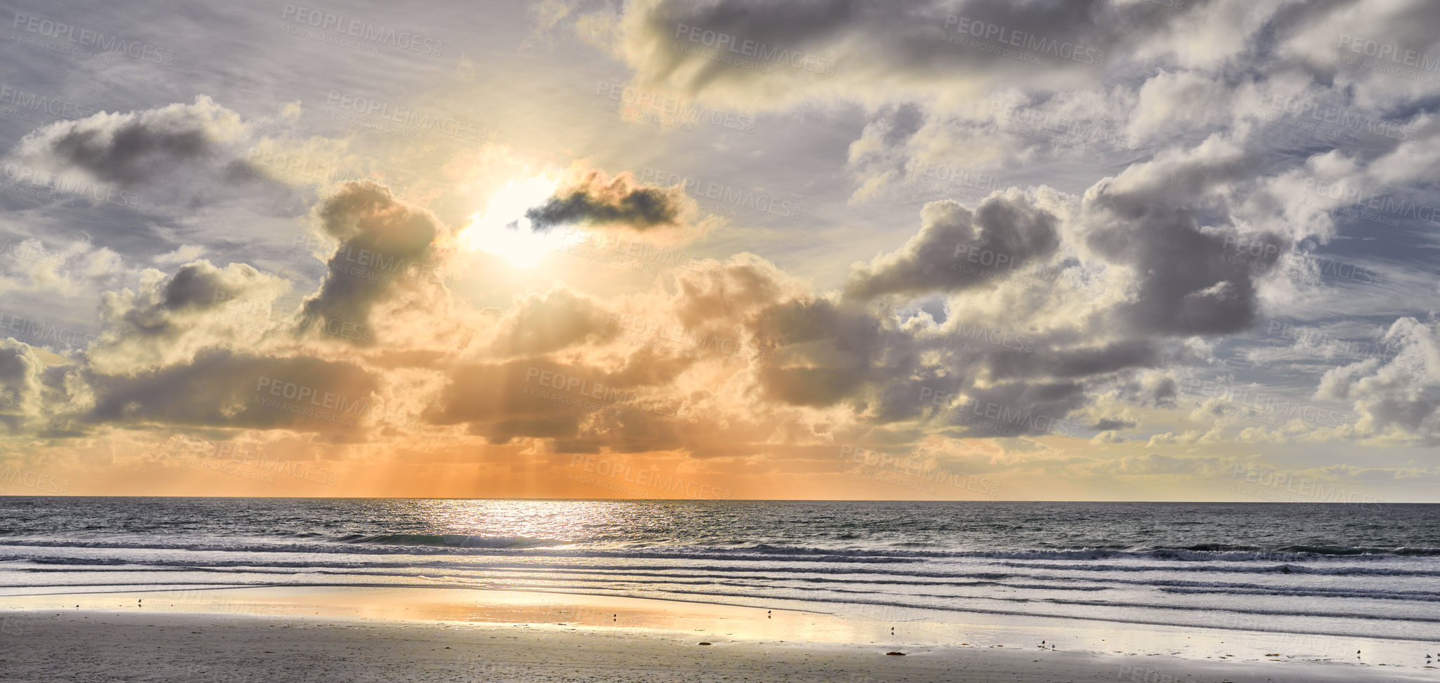 Buy stock photo Seascape and landscape of a golden sunset on the west coast of Jutland in Loekken, Denmark. Beautiful cloudscape on an empty beach at dusk. Clouds over the ocean and sea in the morning with copyspace