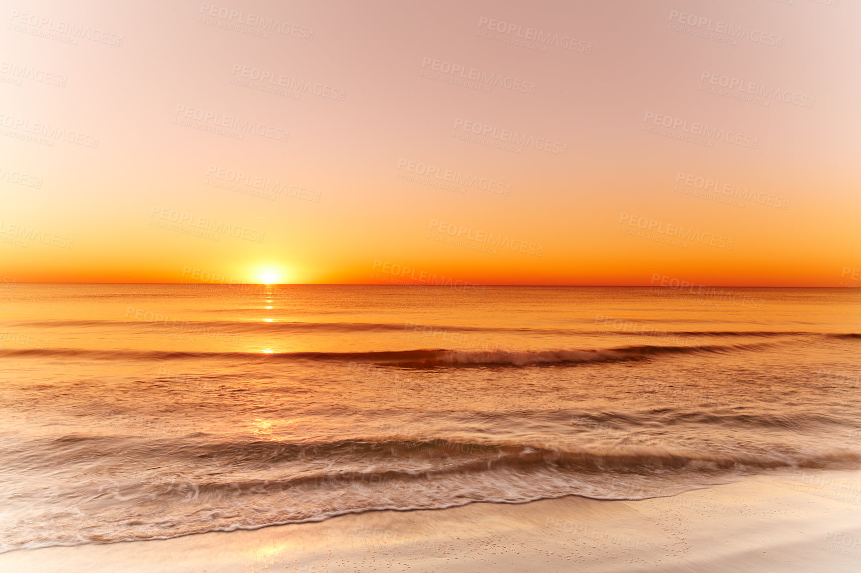 Buy stock photo Landscape and sunset view of an empty beach or ocean at dusk in the evening. Seascape with copy space of a golden sun setting over the horizon on the west coast of Jutland in Loekken, Denmark