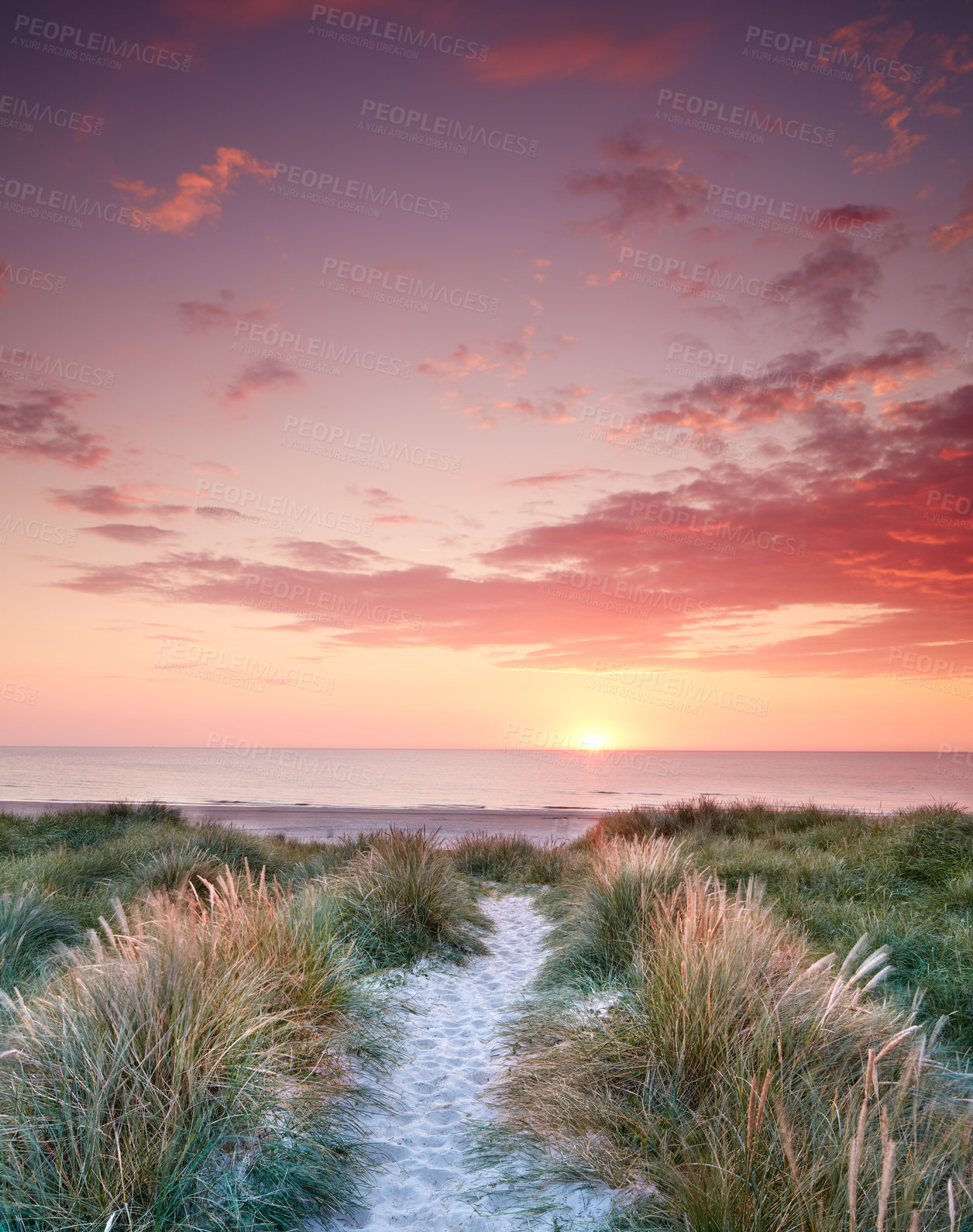 Buy stock photo Seascape and landscape of golden sunset on the west coast of Jutland in Loekken, Denmark. Sun setting on the horizon on an empty beach at dusk over the ocean and sea at night with copyspace