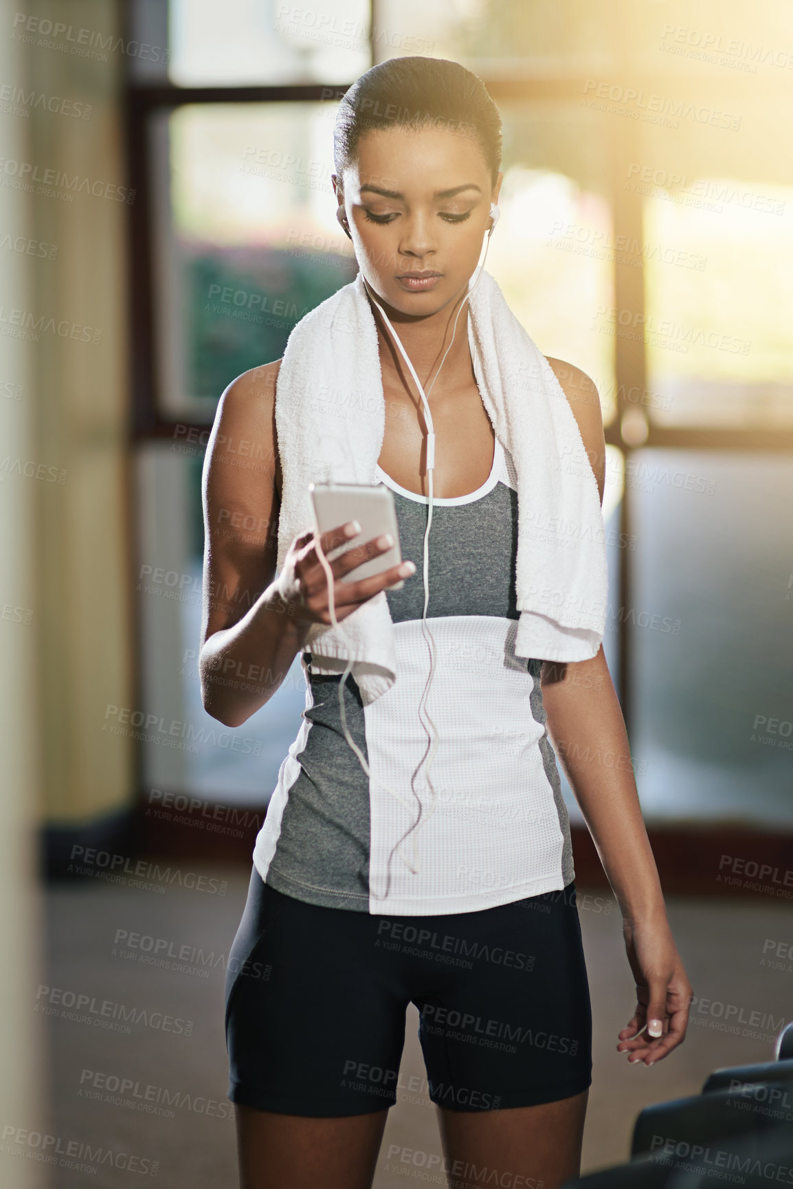 Buy stock photo Gym, woman and smartphone with earphones for music on exercise break, fitness and routine. Female person, workout and mobile phone for songs, album and playlist with training for health and wellbeing