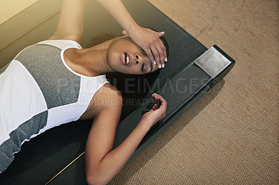 Buy stock photo Headache, tired and black woman lying on treadmill after workout, exercise and training routine for wellness. Challenge, stress and athlete with fatigue from gym, cardio and fitness at health center