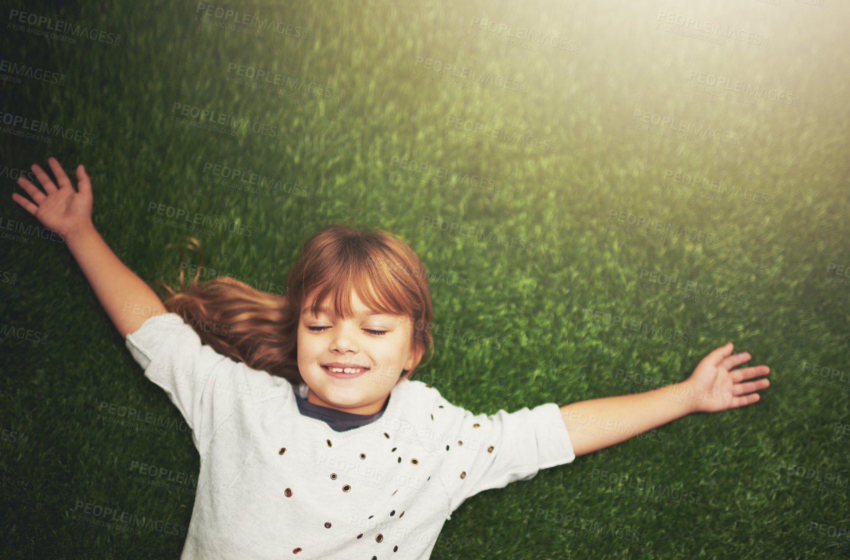 Buy stock photo Happy, top view and child on grass for relax, playful fun and happiness in garden. Family, nature and above of young girl for childhood, playing and freedom on weekend, vacation or holiday outdoors 