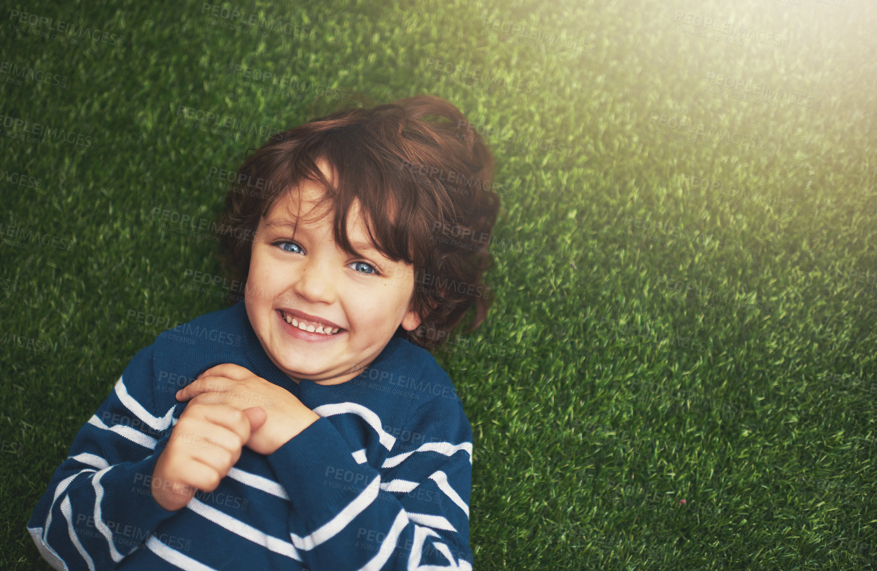 Buy stock photo Happy, youth and portrait of boy on grass for relax, playful fun and happiness in garden. Family, nature and above of kid for childhood, playing and freedom on weekend, vacation or holiday outdoors 