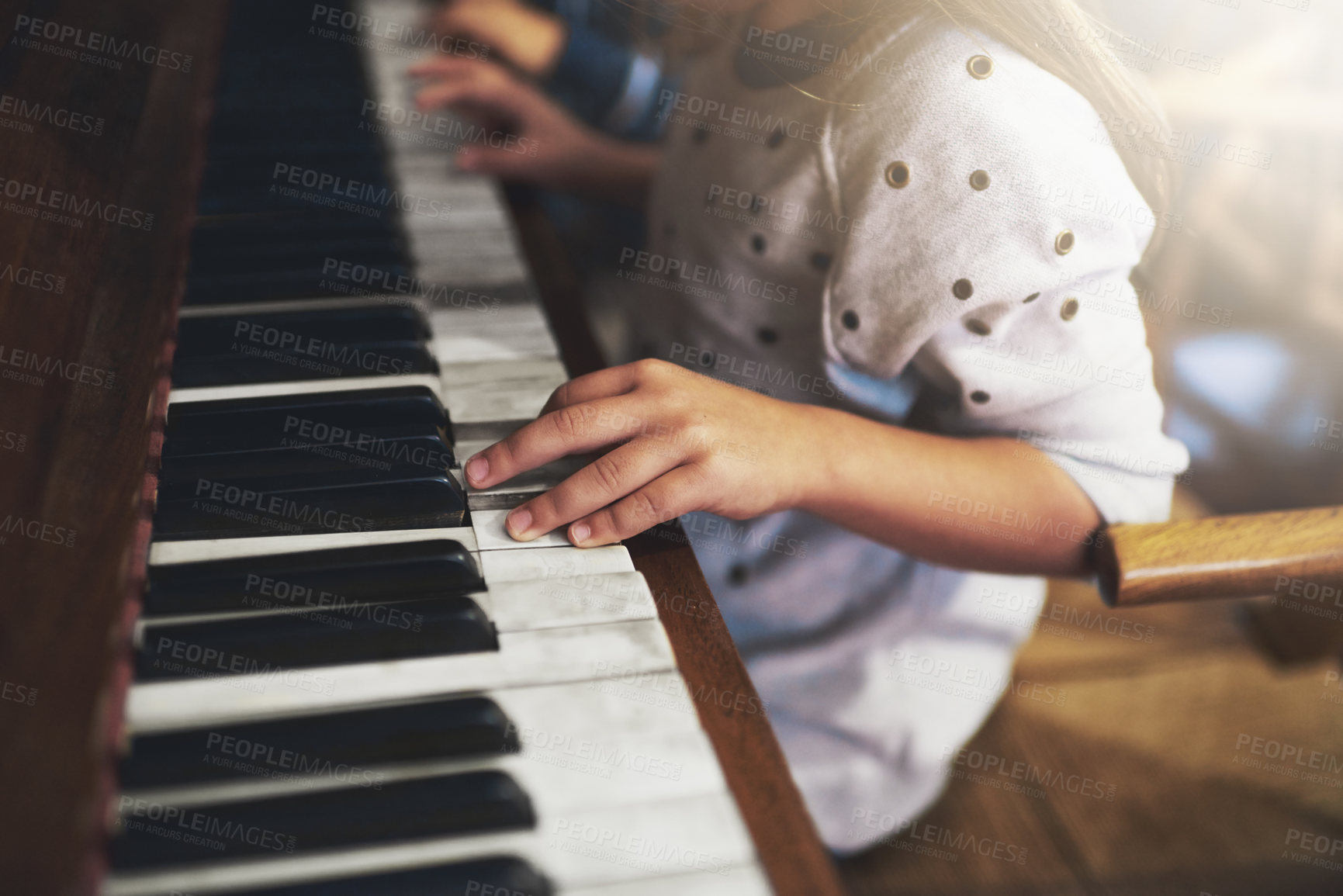 Buy stock photo Cropped shot of a little girl playing the piano