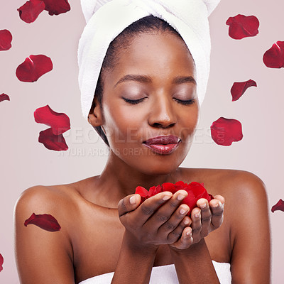 Buy stock photo Dermatology, towel and black woman with red petals, cosmetics or wellness on white studio background. Aesthetic, African person or model with natural beauty or grooming with treatment or healthy skin